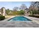 A beautiful in-ground pool with stone patio and a unique stone pool house in a well-maintained backyard at 2631 Habersham Nw Rd, Atlanta, GA 30305