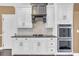 Kitchen with double oven, gas cooktop and custom range hood at 1325 Cameron Glen Dr, Marietta, GA 30062