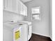 Laundry room with washer, dryer, and upper cabinets at 1325 Cameron Glen Dr, Marietta, GA 30062