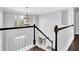 Elegant staircase with dark wood railings and a chandelier at 1325 Cameron Glen Dr, Marietta, GA 30062
