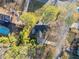 Aerial view of a home showing the backyard pool and deck, along with mature trees and landscaping in the surrounding area at 749 Scarlet Ne Dr, Kennesaw, GA 30144