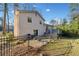 Fenced backyard with patio, mature trees, and lush lawn at 749 Scarlet Ne Dr, Kennesaw, GA 30144