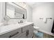 Modern bathroom featuring gray vanity, quartz countertop, black hardware, and gray wood-look tile floor at 749 Scarlet Ne Dr, Kennesaw, GA 30144