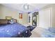 Comfortable bedroom featuring a bed with patterned blanket, closet and area rug at 749 Scarlet Ne Dr, Kennesaw, GA 30144
