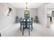 Elegant dining room with a stylish light fixture, seating for eight, and bright natural light at 749 Scarlet Ne Dr, Kennesaw, GA 30144