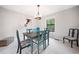 Elegant dining room with a stylish light fixture, seating for six, and bright natural light at 749 Scarlet Ne Dr, Kennesaw, GA 30144