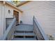 Inviting front entrance featuring a wooden door and covered porch with gray railings at 749 Scarlet Ne Dr, Kennesaw, GA 30144