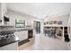 Bright kitchen with white cabinets, black countertops, and a dining area at 749 Scarlet Ne Dr, Kennesaw, GA 30144