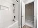 Modern white tiled shower with black hardware and built-in niche at 749 Scarlet Ne Dr, Kennesaw, GA 30144