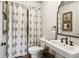 Charming bathroom with pedestal sink, shower, and patterned curtains at 2460 Oldfield Rd, Atlanta, GA 30327