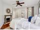 Bright bedroom with fireplace, hardwood floors, and ample natural light at 2460 Oldfield Rd, Atlanta, GA 30327