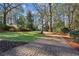 Long driveway leading to a charming house nestled among tall trees at 2460 Oldfield Rd, Atlanta, GA 30327