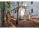 White house exterior with gray deck and steps, surrounded by trees and pine straw at 2460 Oldfield Rd, Atlanta, GA 30327