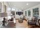 Bright sunroom with built-in entertainment center and hardwood floors at 2460 Oldfield Rd, Atlanta, GA 30327