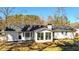 View of the back of the house, featuring a sunroom and well-maintained yard at 2622 Marcia Dr, Lawrenceville, GA 30044