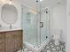 Modern bathroom with a frameless glass shower, decorative tile, and geometric patterned floors at 2622 Marcia Dr, Lawrenceville, GA 30044