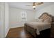 This bedroom features wood floors, a window, and a neutral color scheme at 2622 Marcia Dr, Lawrenceville, GA 30044