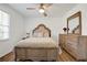 This bedroom features wood floors, a ceiling fan, and natural lighting at 2622 Marcia Dr, Lawrenceville, GA 30044