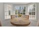 Sunlit breakfast nook with round table and chairs near a large bay window at 2622 Marcia Dr, Lawrenceville, GA 30044