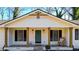 Inviting front porch with stone base, decorative columns, and stylish rocking chair at 2622 Marcia Dr, Lawrenceville, GA 30044