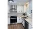 Bright kitchen with stainless steel appliances, white cabinets, hexagon tile backsplash and granite counters at 2622 Marcia Dr, Lawrenceville, GA 30044