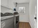 This laundry room features modern appliances, wood floors, and natural lighting at 2622 Marcia Dr, Lawrenceville, GA 30044