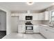 Modern kitchen with white cabinets, stainless steel appliances, and marble flooring at 5815 Feldwood Rd, Atlanta, GA 30349