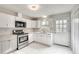 Modern kitchen with white cabinets, stainless steel appliances, and marble flooring at 5815 Feldwood Rd, Atlanta, GA 30349