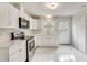 Modern kitchen with white cabinets, stainless steel appliances, and marble flooring at 5815 Feldwood Rd, Atlanta, GA 30349