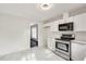 Modern kitchen with white cabinets, stainless steel appliances, and marble flooring at 5815 Feldwood Rd, Atlanta, GA 30349