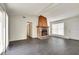 Living room with brick fireplace, wood mantle, and dark gray flooring at 5815 Feldwood Rd, Atlanta, GA 30349