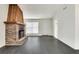 Bright living room featuring a brick fireplace and dark gray laminate flooring at 5815 Feldwood Rd, Atlanta, GA 30349