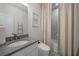 Clean bathroom with gray tile, a tub, and a modern toilet at 1049 Brandsford Nw St, Atlanta, GA 30318