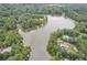 Aerial view showcasing lake surrounded by tree-lined properties and homes at 212 Teepee Trl, Whitesburg, GA 30185