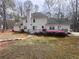 Spacious backyard featuring a deck with pink flowering bushes around the perimeter at 212 Teepee Trl, Whitesburg, GA 30185
