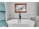 Modern bathroom featuring a freestanding soaking tub, marble accents, and stylish decor at 212 Teepee Trl, Whitesburg, GA 30185