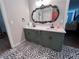Bathroom featuring double sinks, an ornate mirror and stylish patterned flooring at 212 Teepee Trl, Whitesburg, GA 30185