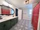 Spacious bathroom with double sinks, a large mirror, and decorative patterned floors at 212 Teepee Trl, Whitesburg, GA 30185