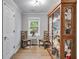 Cozy room with display cabinet, two chairs, neutral walls and wood floors at 212 Teepee Trl, Whitesburg, GA 30185