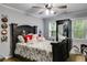 Comfortable bedroom with dark wood bed frame, wood floors and two windows at 212 Teepee Trl, Whitesburg, GA 30185