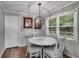 Charming breakfast nook with a round table, upholstered chairs, and natural light at 212 Teepee Trl, Whitesburg, GA 30185
