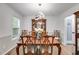 Elegant dining room featuring hardwood floors, modern lighting, and classic wood furniture at 212 Teepee Trl, Whitesburg, GA 30185