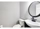 Clean half bathroom featuring modern fixtures, including a stylish sink and toilet at 212 Teepee Trl, Whitesburg, GA 30185