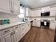 Modern kitchen featuring white cabinets, stainless steel appliances, and quartz countertops at 212 Teepee Trl, Whitesburg, GA 30185