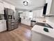 Open kitchen with stainless steel appliances, white cabinets and a eat in dining area at 212 Teepee Trl, Whitesburg, GA 30185