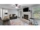 Spacious living room with a decorative fireplace, hardwood floors and a comfortable sofa at 212 Teepee Trl, Whitesburg, GA 30185