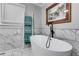 Modern main bathroom featuring a soaking tub, marble walls, and stylish fixtures at 212 Teepee Trl, Whitesburg, GA 30185