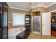 Bathroom with corner soaking tub, walk-in shower, and built-in shelving at 2120 Shaffer Rd, Cumming, GA 30041