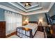 Bedroom with TV, ceiling fan, and decorative storage at 2120 Shaffer Rd, Cumming, GA 30041