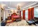 Main bedroom with ornate bed, chandelier, and plush seating at 2120 Shaffer Rd, Cumming, GA 30041